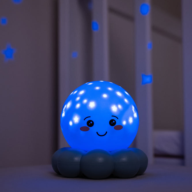 Blue night light with a smiling face on a bed in a bedroom setting