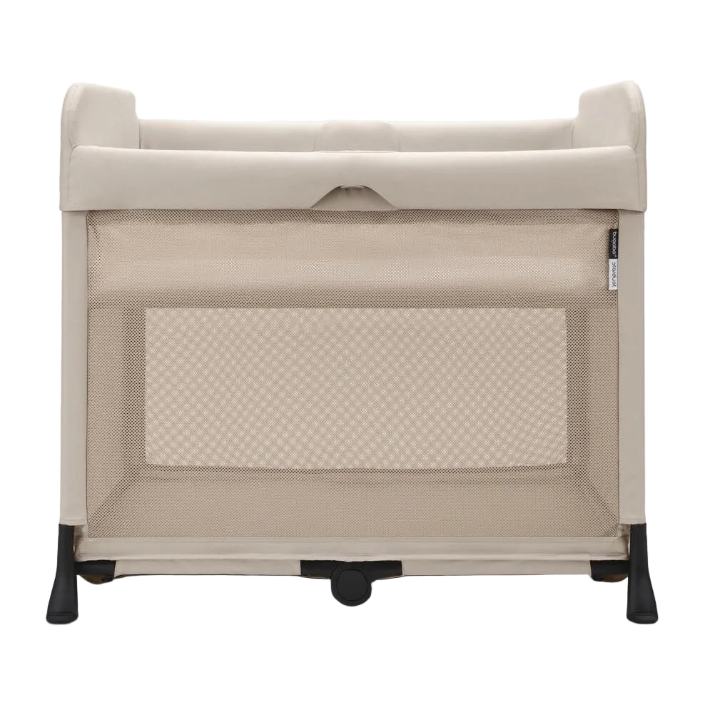 A portable baby playpen in a warm beige fabric with black wheels and feet, shown from the front against a light gray background.