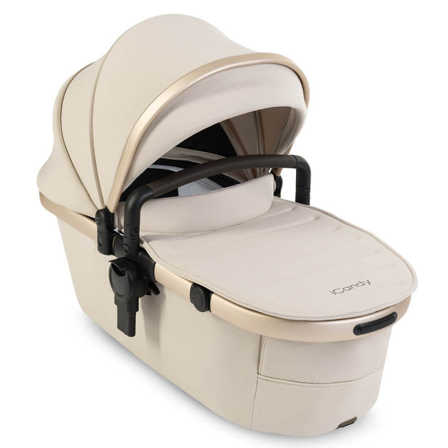 Beige baby carrier with black accents on a white background