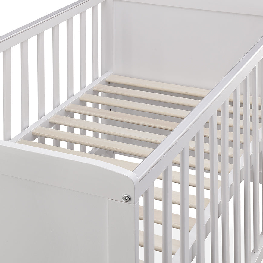 White crib with wooden slats on a white background