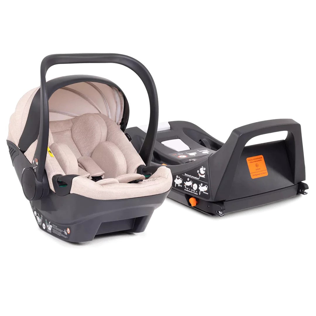 A baby car seat with a beige and black interior and base, shown next to its matching black base on a clean white background.
