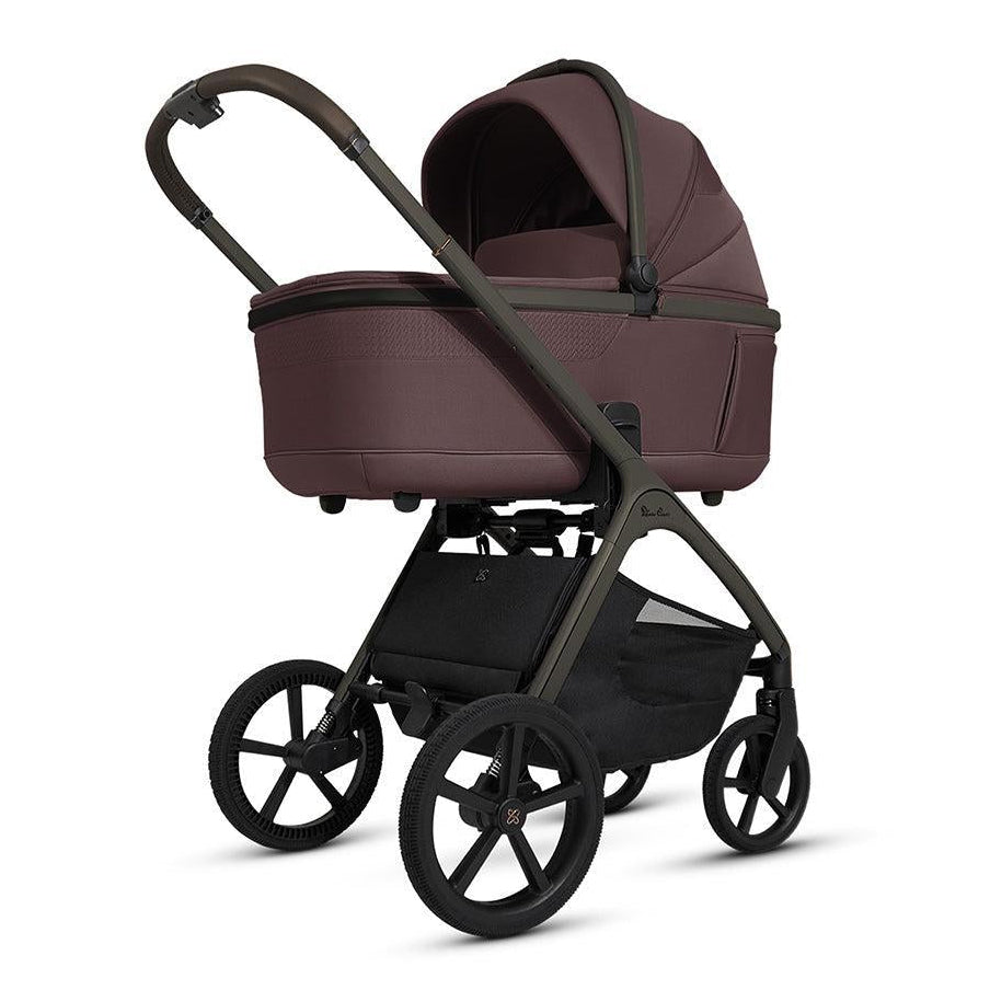 Baby stroller with maroon bassinet on a white background
