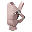 A dusty pink baby carrier seat pad by Bumblerise, shown on a clean white background. The padded insert is attached to a matching adjustable shoulder strap and waist belt, with the brand name 'Bumblerise' visible in white text on the fabric.
