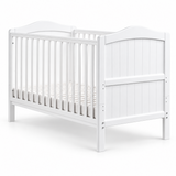 White wooden toddler bed with a convertible crib design, featuring a slatted mattress base, arched headboard, and vertical panel details, shown on a clean white background.