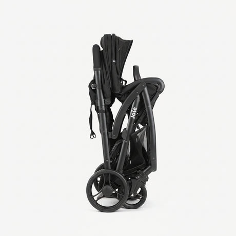 Black stroller folded and compact on a white background