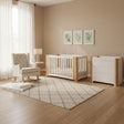 Collection of baby furniture including a crib, rocking chair, and changing table on a white background.