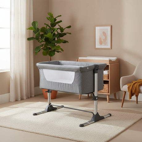 Gray baby crib with white mattress on a white background
