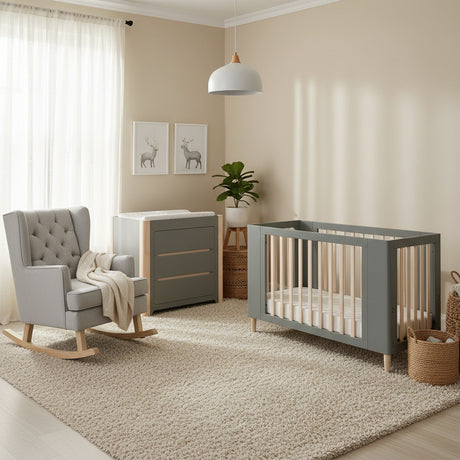 Collection of gray nursery furniture including a crib, rocking chair, and changing table on a white background.