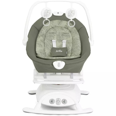 A Jula baby swing and seat bassinet combo in sage green and white, featuring a padded seat cushion with the Jula logo, a white rocking base, and a white safety harness frame.