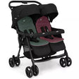 A double stroller with a black frame and canopy, featuring two separate seats with dark green and burgundy fabric, shown on a plain white background.