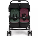 A double stroller with a black frame and canopy, featuring two separate seats with quilted cushions in dark green and burgundy, shown against a plain white background.