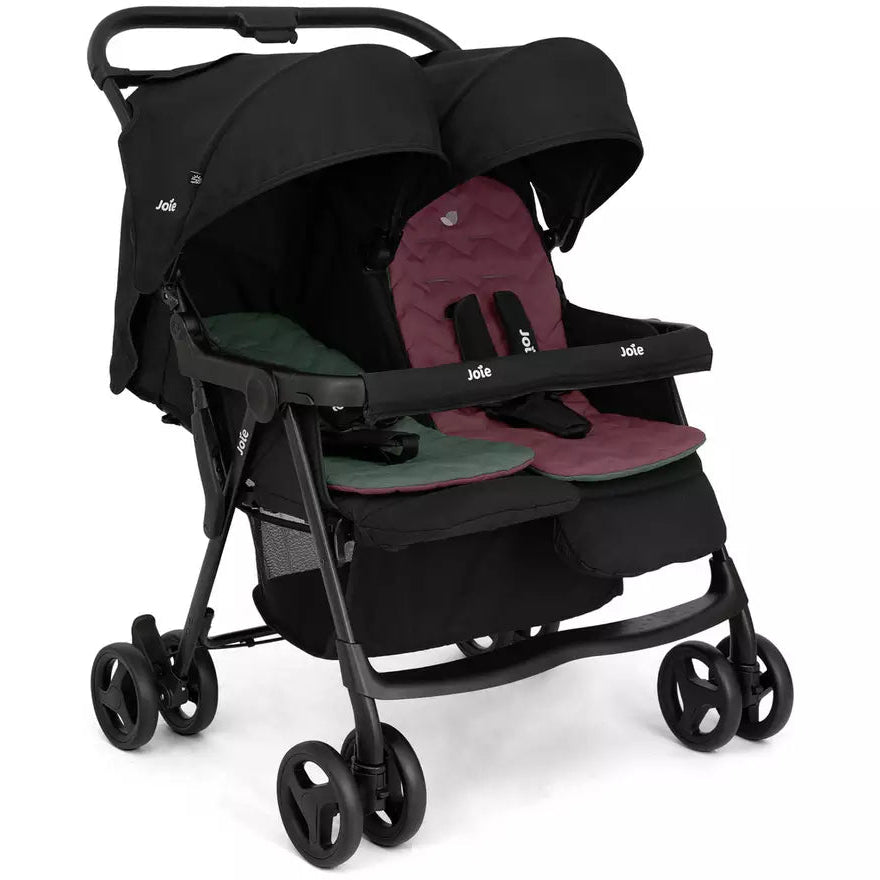 A compact double stroller in black with burgundy and green seat liners, shown from a three-quarter angle on a white background.