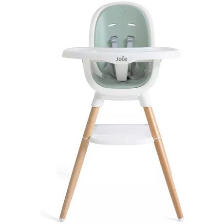 A Joie high chair with a mint green and white seat, white tray, and light natural wood legs, shown against a plain white background.