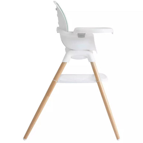 A modern white baby high chair with light natural wood legs, shown from a side profile view against a solid white background.