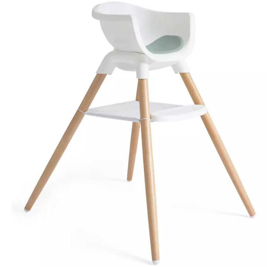 A modern high chair with a white molded plastic seat and backrest, supported by four natural wood legs, shown on a clean white background.