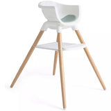 A modern high chair with a white molded plastic seat and backrest, supported by four natural wood legs, shown on a clean white background.