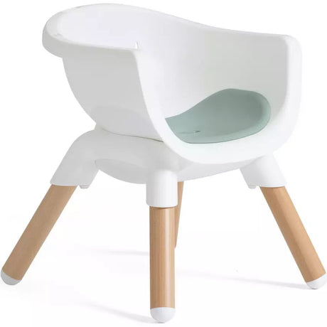A modern white molded plastic baby chair with four natural wood legs and a light mint green non-toxic seat insert, shown on a white background.