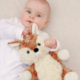Baby holding a plush toy with a neutral background