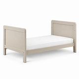 A light beige wooden toddler bed with a matching headboard and footboard, shown with a white mattress on a clean white background.