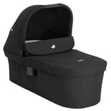 A black baby travel seat bassinet with an integrated canopy, shown at a three-quarter angle on a solid white background.