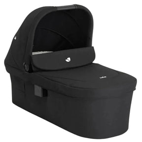 A black baby travel seat bassinet with an integrated canopy, shown at a three-quarter angle on a solid white background.