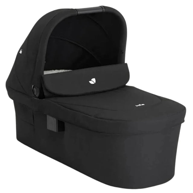 A black baby travel seat bassinet with an integrated canopy, shown at a three-quarter angle on a solid white background.