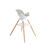 White high chair with wooden legs on a white background