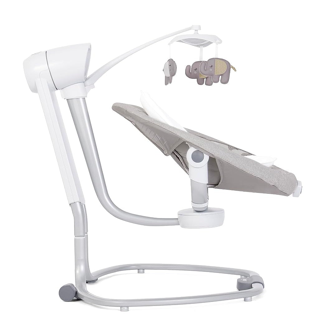 A modern baby swing and bassinet combo with a white plastic frame, a gray fabric bassinet seat, and a matching elephant mobile hanging from the top, shown on a solid white background.
