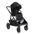 A black baby stroller and car seat combo with a matching black canopy, shown from a three-quarter angle on a solid white background.