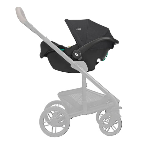 A black stroller bassinet combo from Bugaboo, shown mounted on a light gray stroller frame against a solid off-white background.