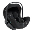 A black infant car seat with a matching canopy and harness, shown from a three-quarter angle on a solid white background.