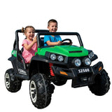 Two children in a green toy off-road vehicle on a clear day.