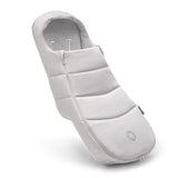 A light gray padded baby wrap or footmuff with horizontal quilted sections, shown floating at an angle on a clean white background.