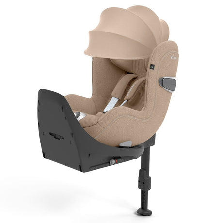 Beige baby car seat with black base on a white background