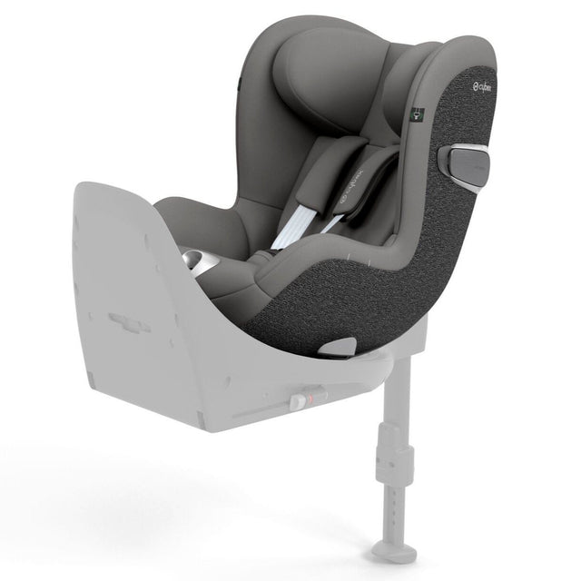 A grey and black baby car seat mounted on a light grey base, shown from a three-quarters angle against a solid white background.