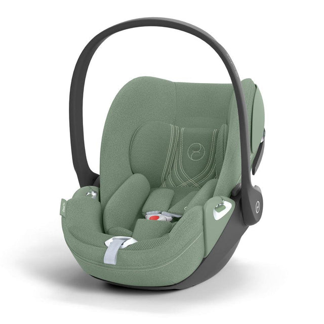 Green baby car seat with black frame on a white background