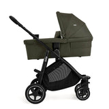 Green baby stroller with black frame on a white background