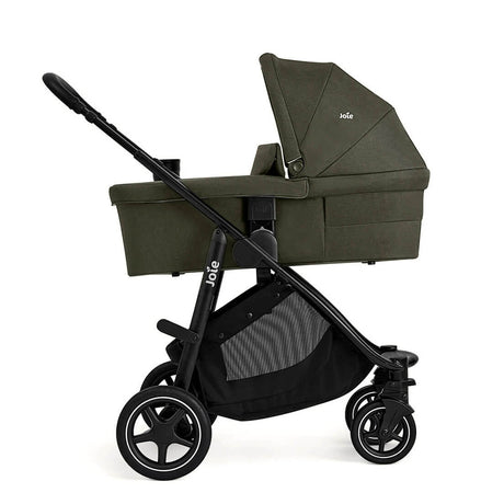 Green baby stroller with black frame on a white background