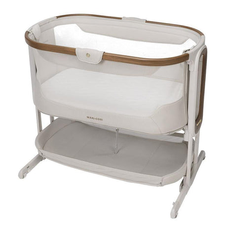 Baby crib with mesh side and wooden accents on a white background