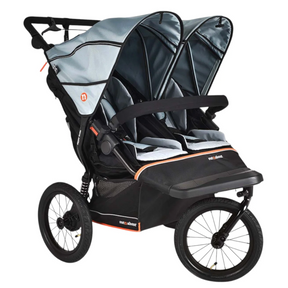 A double stroller travel system with two seats, dual canopies, and a large rear footrest, shown on a plain white background. The stroller features a black frame and wheels with gray and black fabric seats and canopies, accented by thin orange stripes.