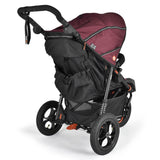 A three-wheel stroller with a black frame and a burgundy maroon canopy, shown from a three-quarter angle on a white background.