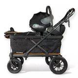 A black stroller travel system with a bassinet, infant car seat, and handle, featuring orange accent lines and a black storage bag, shown on a white background.