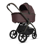 Baby stroller with maroon bassinet on a white background