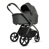 Green baby stroller with black wheels on a white background