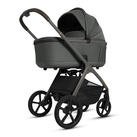Green baby stroller with black wheels on a white background