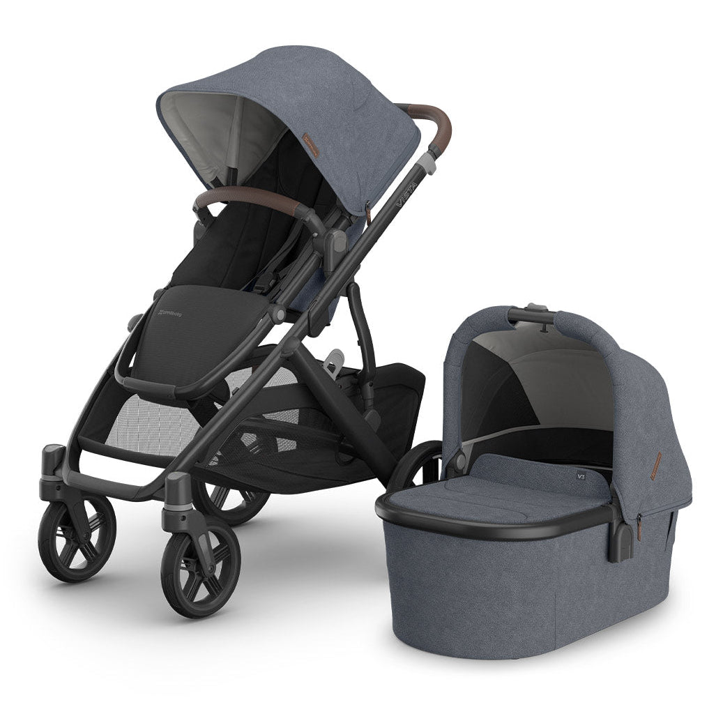 Gray stroller with attached bassinet on a white background