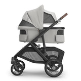 Gray and black stroller on a white background