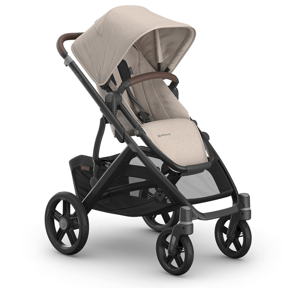 A premium stroller with a light beige fabric canopy and seat liner, paired with a dark gray frame and black wheels, shown on a clean white background.